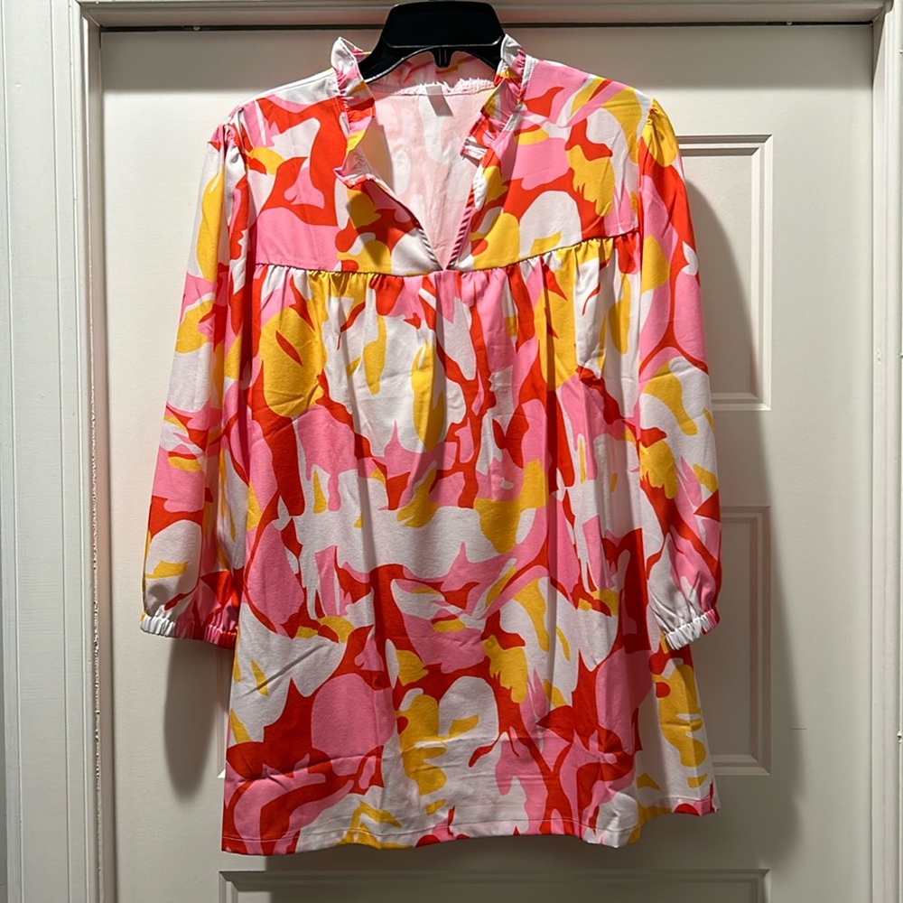 Beautiful womens top. Brand new without tags. Cute ruffle neck